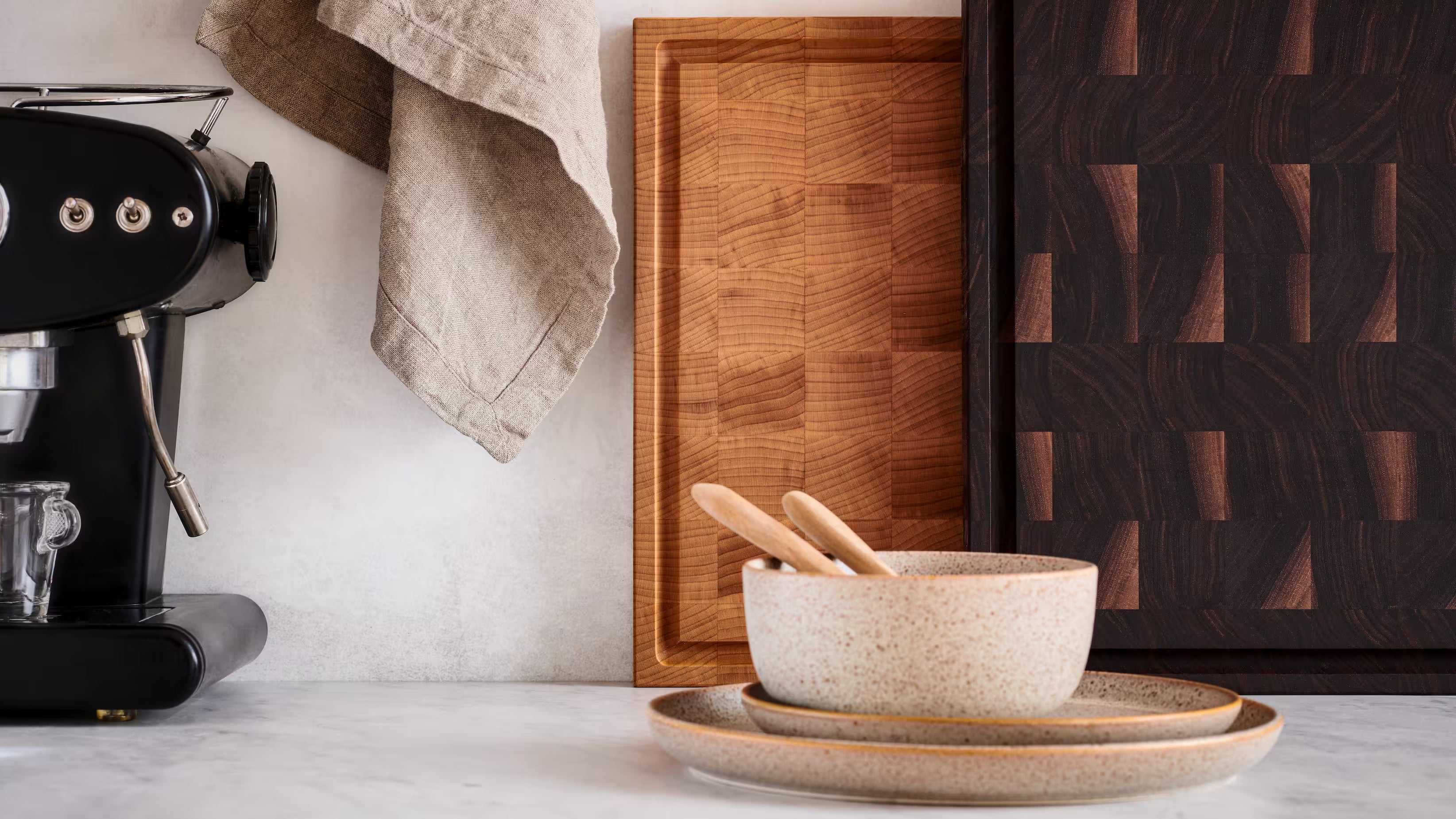 Maison Liverani heirloom end-grain cutting boards in walnut and maple on a marble countertop